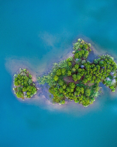 Drone picture of a small, green island